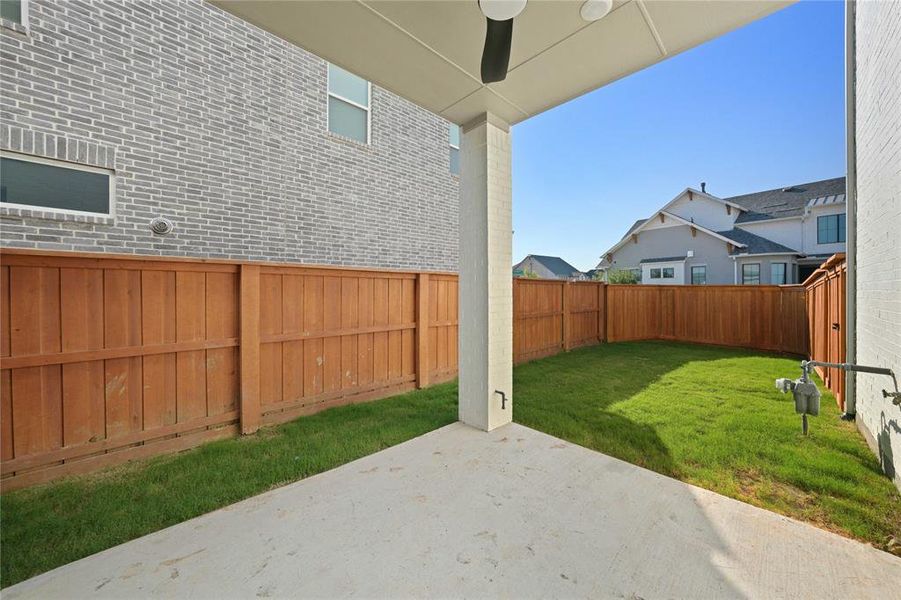 Fenced backyard with a patio and a ceiling fan Fenced backyard with a patio and a ceiling fan