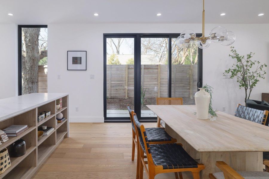 Dining space with light wood finished floors, recessed lighting, and plenty of natural light