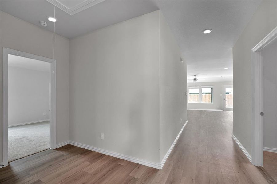 Corridor featuring attic access, light wood-type flooring, and recessed lighting Corridor featuring attic access, light wood-type flooring, and recessed lighting