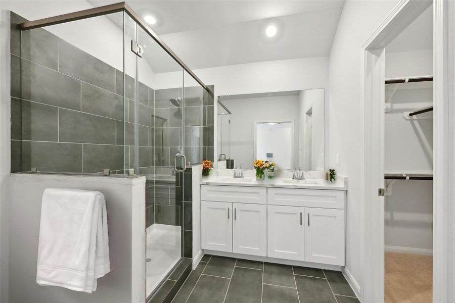 This primary bathroom serves as a genuine sanctuary that merges opulence with practicality.
