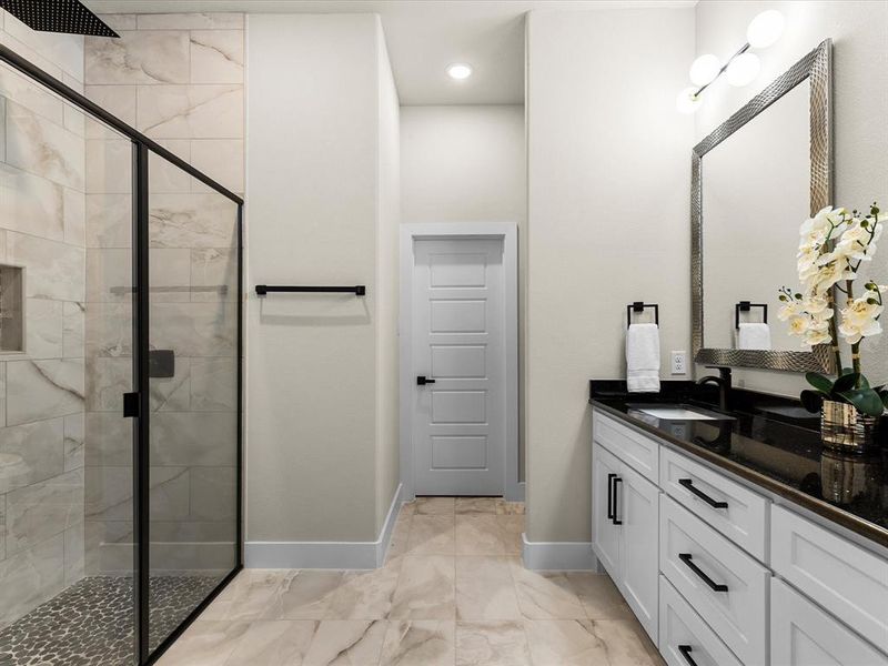 Full bath featuring a shower stall, vanity, marble look tile flooring, and recessed lighting