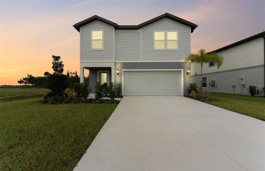 Front exterior of a new home in Oakfield Trails, Parrish, FL, highlighting curb appeal (Image 19).