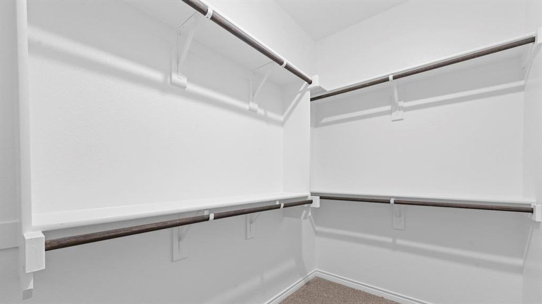 Walk in closet with light colored carpet Walk in closet with light colored carpet