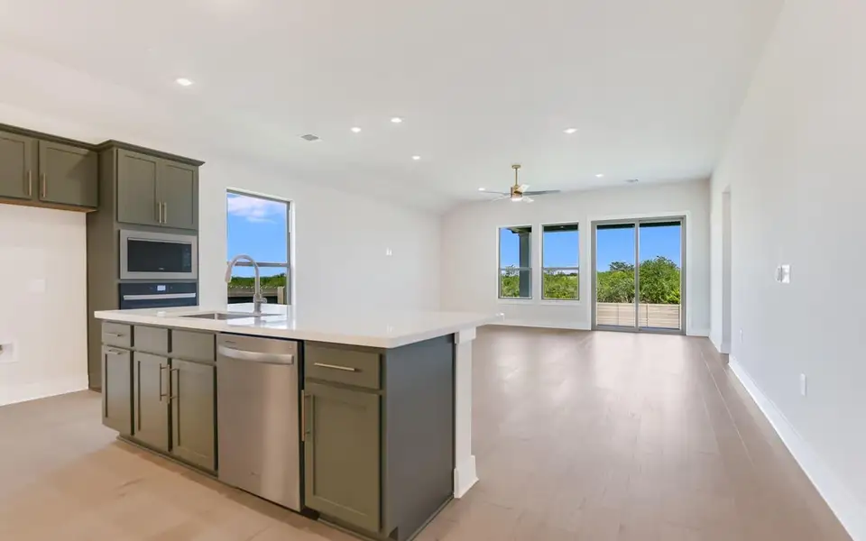 Kitchen with open floor plan, stainless steel appliances, an island with sink, healthy amount of natural light, and recessed lighting