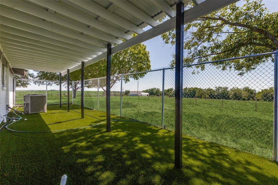 View of artificial turf and fenced dog run at original home View of artificial turf and fenced dog run at original home
