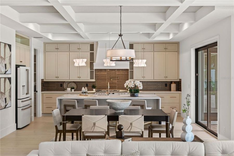 Kitchen with Premium Café Appliance suite, walk in pantry with cabinets & shelving, large island with quartz waterfall counters, designer pendant lighting, gas range with pot-filler and custom white oak fluted hood Kitchen with Premium Café Appliance suite, walk in pantry with cabinets & shelving, large island with quartz waterfall counters, designer pendant lighting, gas range with pot-filler and custom white oak fluted hood