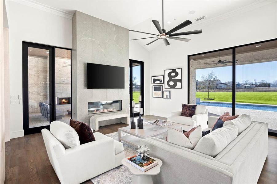 This great room features a linear gas fireplace and opens to the outdoor living.