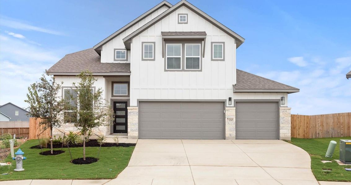 Front exterior of a new home in Village at Three Oaks, Seguin, TX, highlighting curb appeal (Image 2). Front exterior of a new home in Village at Three Oaks, Seguin, TX, highlighting curb appeal (Image 2).