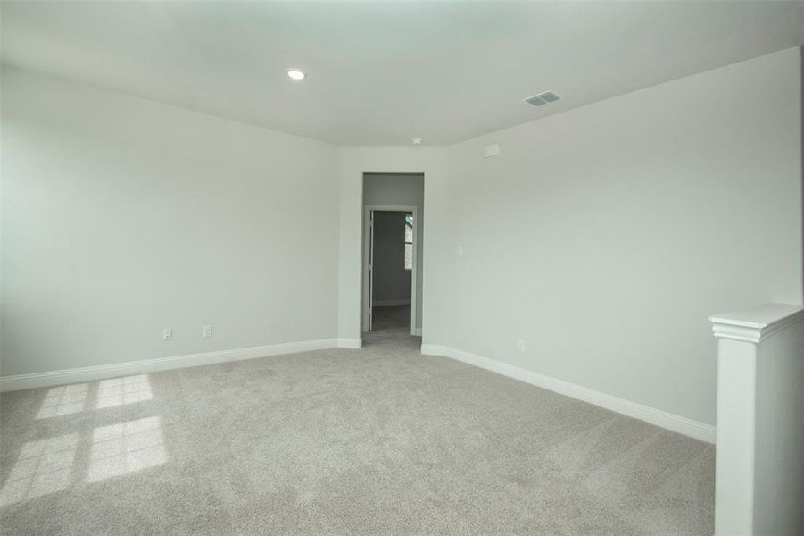 Empty room featuring light colored carpet, recessed lighting, and baseboards Empty room featuring light colored carpet, recessed lighting, and baseboards