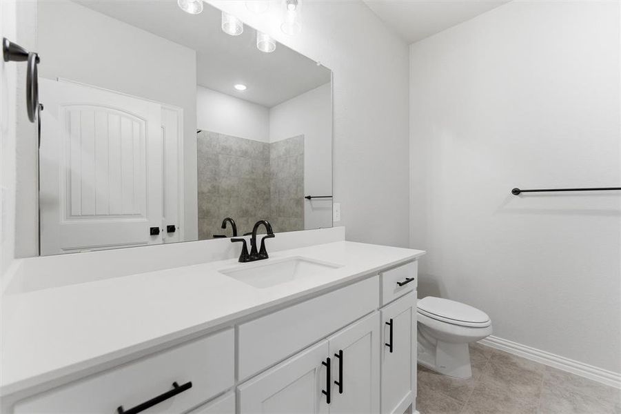Bathroom with vanity and light tile patterned floors