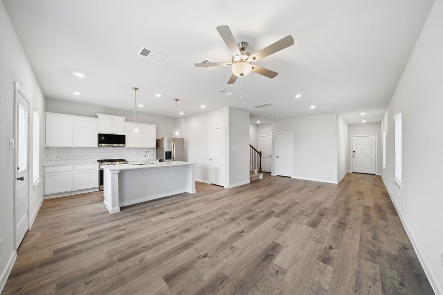 A large kitchen with white cabinets. A large kitchen with white cabinets.