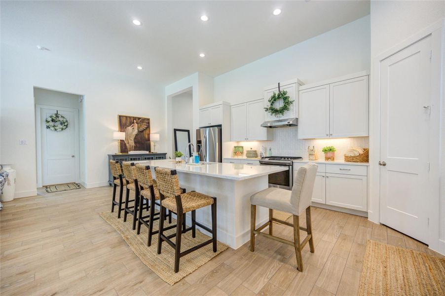 Spacious kitchen featuring abundant workspace, ample storage, and a central island. Spacious kitchen featuring abundant workspace, ample storage, and a central island.