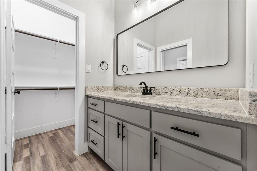 Bathroom featuring hardwood / wood-style floors and vanity