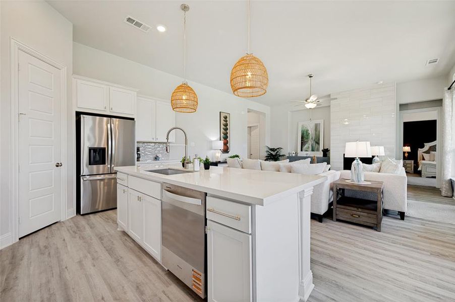 Designed to impress, this stunning gourmet kitchen showcases an oversized gathering island, quartz countertops, double ovens, stainless steel appliances, and custom cabinetry. Elegant pendant lighting and a seamless connection to the living and dining spaces create an exceptional environment for entertaining and everyday living alike Designed to impress, this stunning gourmet kitchen showcases an oversized gathering island, quartz countertops, double ovens, stainless steel appliances, and custom cabinetry. Elegant pendant lighting and a seamless connection to the living and dining spaces create an exceptional environment for entertaining and everyday living alike