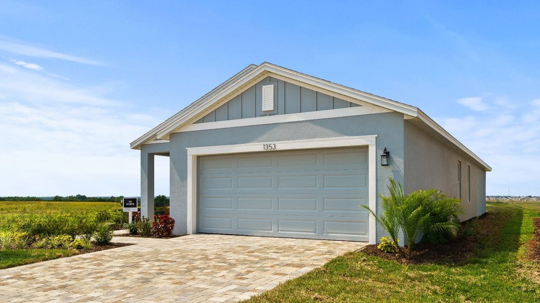 The Atlantic at Hamilton Bluff offers a clean, modern exterior with a 2-car garage, paver driveway, and inviting front entry.