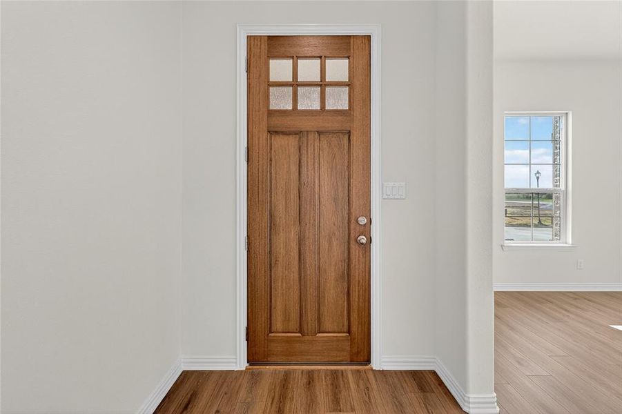 Entrance foyer featuring plenty of natural light and wood finished floors