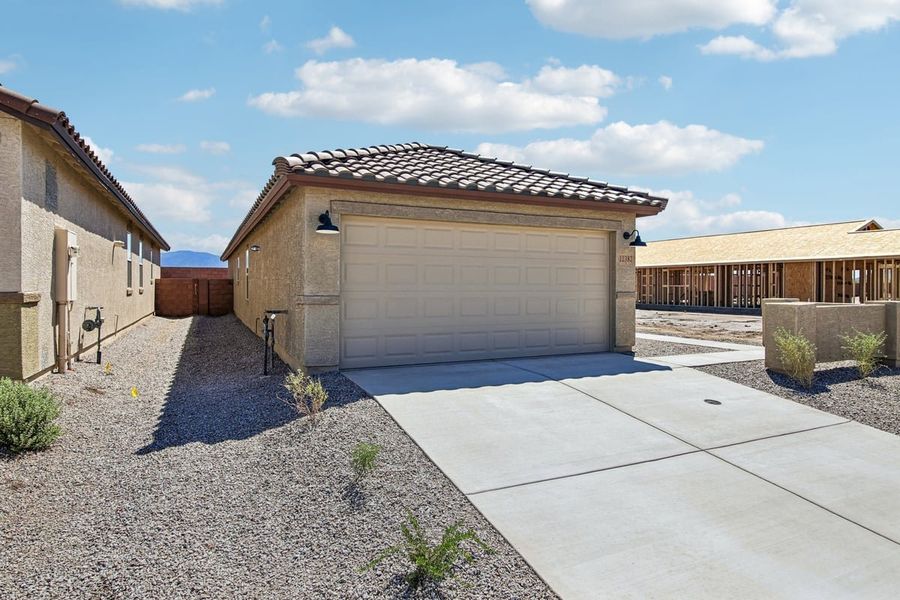 Front exterior of a new home in Mandarina Reserve, Marana, AZ, highlighting curb appeal (Image 16).