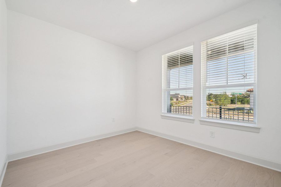 Empty room with light wood-style floors and baseboards Empty room with light wood-style floors and baseboards