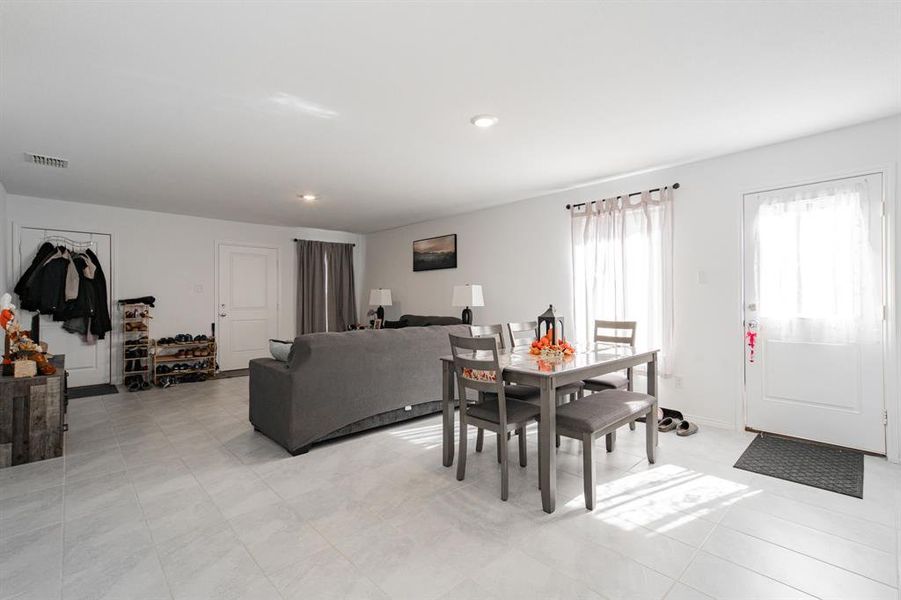 Dining area featuring recessed lighting and light tile patterned flooring