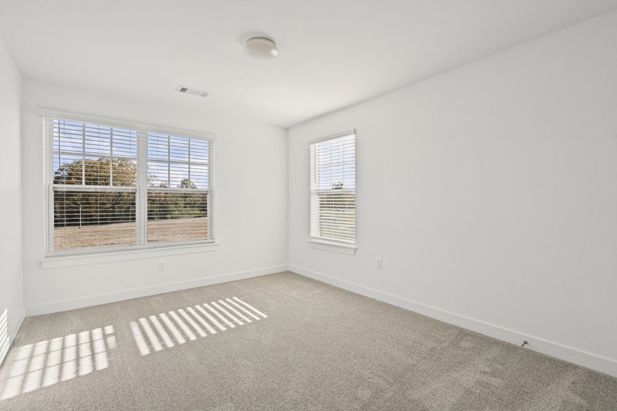 Carpeted spare room with baseboards