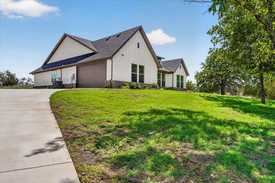 Front exterior of a new home in Monarch Manor, Poolville, TX, highlighting curb appeal (Image 31).