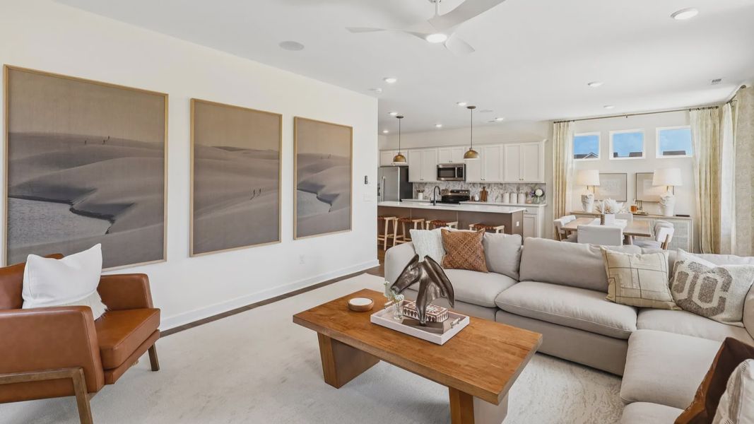 Gathering room with ceiling fan, windows, and fireplace
