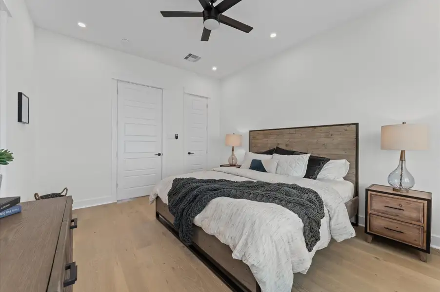 This spacious second-floor primary bedroom exudes modern elegance with its sleek engineered wood flooring that adds warmth and texture underfoot. High ceilings and big windows amplify the sense of openness, allowing natural light to cascade in and highlight the room’s charm. Whether styled with minimalist furnishings or layered with cozy accents, the space offers a serene retreat. This spacious second-floor primary bedroom exudes modern elegance with its sleek engineered wood flooring that adds warmth and texture underfoot. High ceilings and big windows amplify the sense of openness, allowing natural light to cascade in and highlight the room’s charm. Whether styled with minimalist furnishings or layered with cozy accents, the space offers a serene retreat.