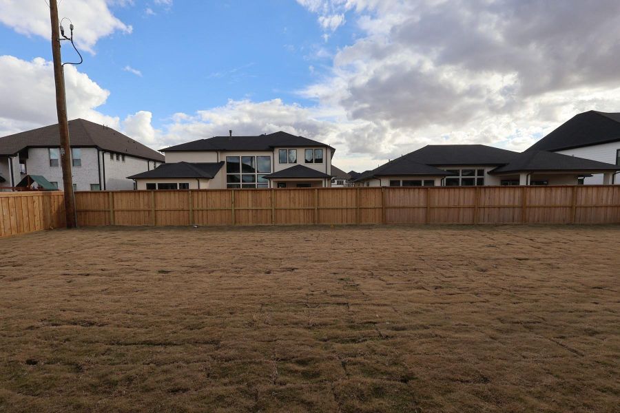 Exterior details and patio area of a home in Dunham Pointe, Cypress (Image 26).