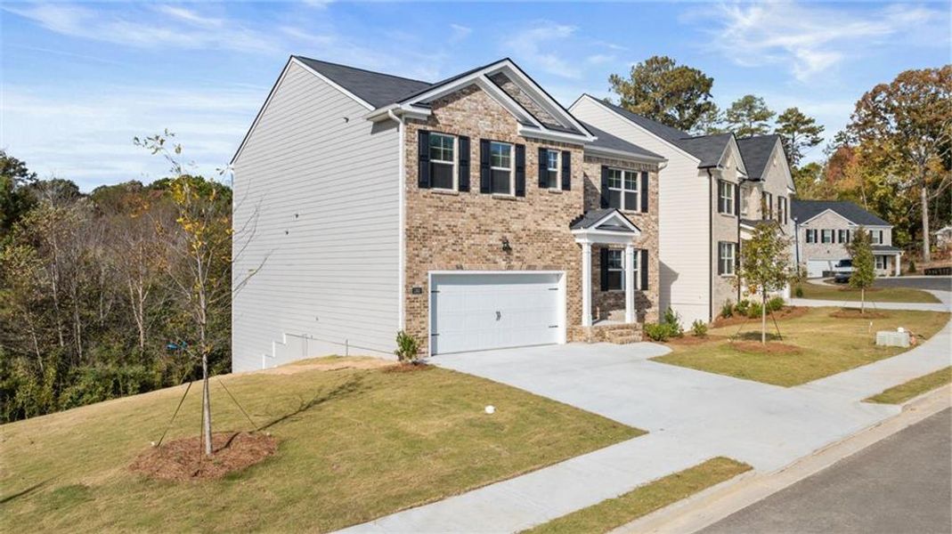 Front exterior of a new home in Brooks Station, Dacula, GA, highlighting curb appeal (Image 1).