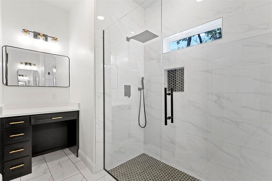 Bathroom with a shower with door and vanity