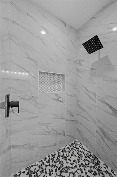 Bathroom featuring a tile shower