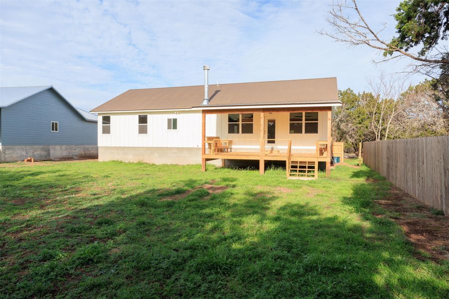 Rear view of property with a wooden deck and a metal roof