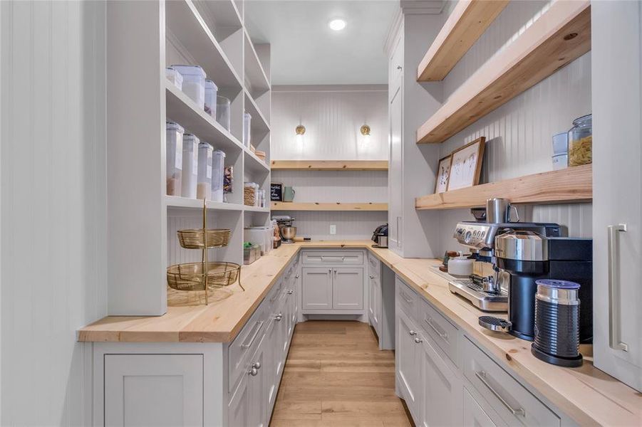 Custom pantry with "Costco" door connected to garage for groceries