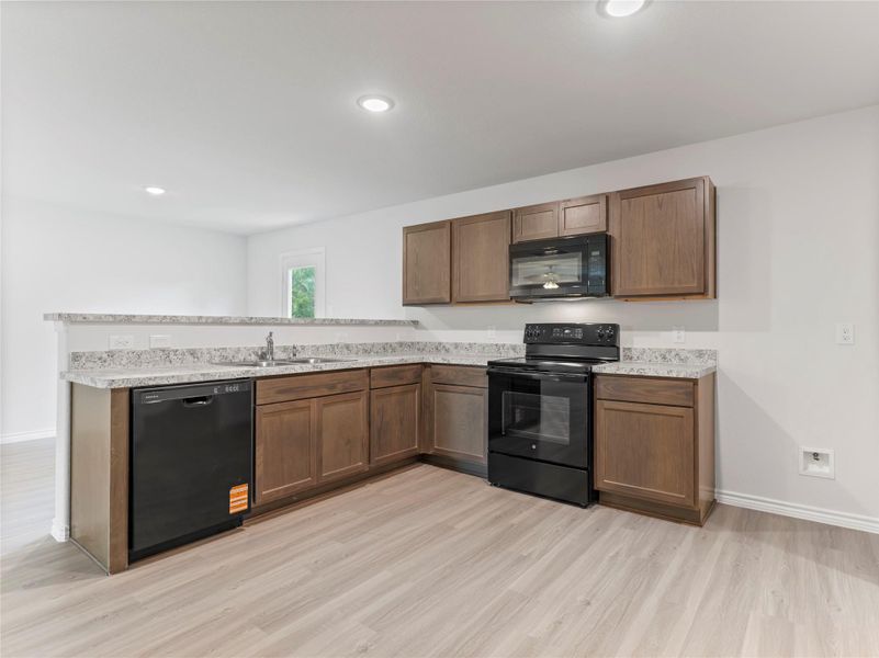 Sleek new black appliances enhance the modern kitchen. Sleek new black appliances enhance the modern kitchen.