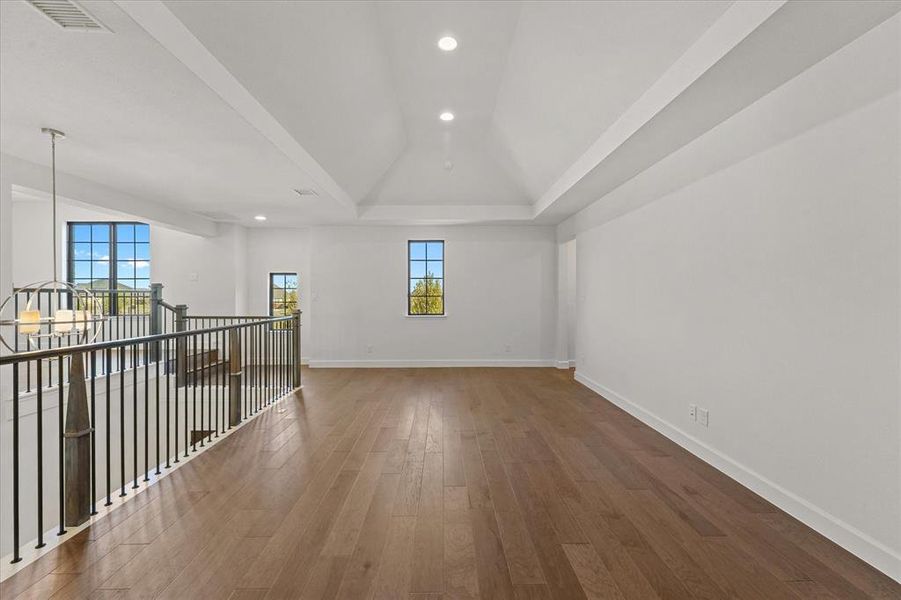 Additional living space with recessed lighting, wood finished floors, a chandelier, and vaulted ceiling