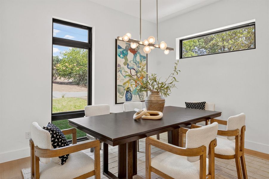 The dining room has views of the crepe myrtle tree and lavender out front. The dining room has views of the crepe myrtle tree and lavender out front.