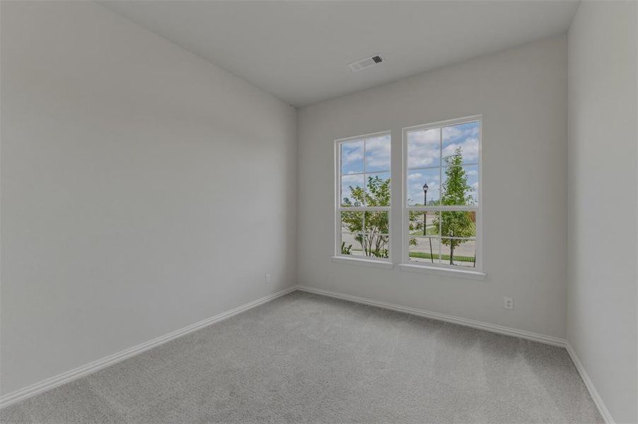 Room featuring a vaulted ceiling and dual pane windows Room featuring a vaulted ceiling and dual pane windows