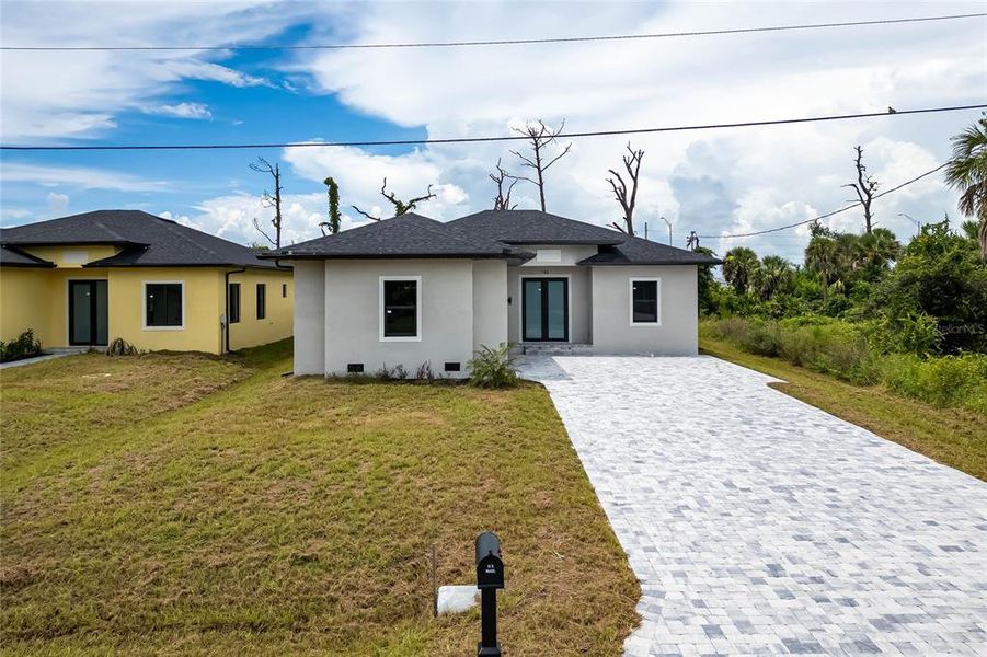 Front exterior of a new home in , Rotonda West, FL, highlighting curb appeal (Image 26).