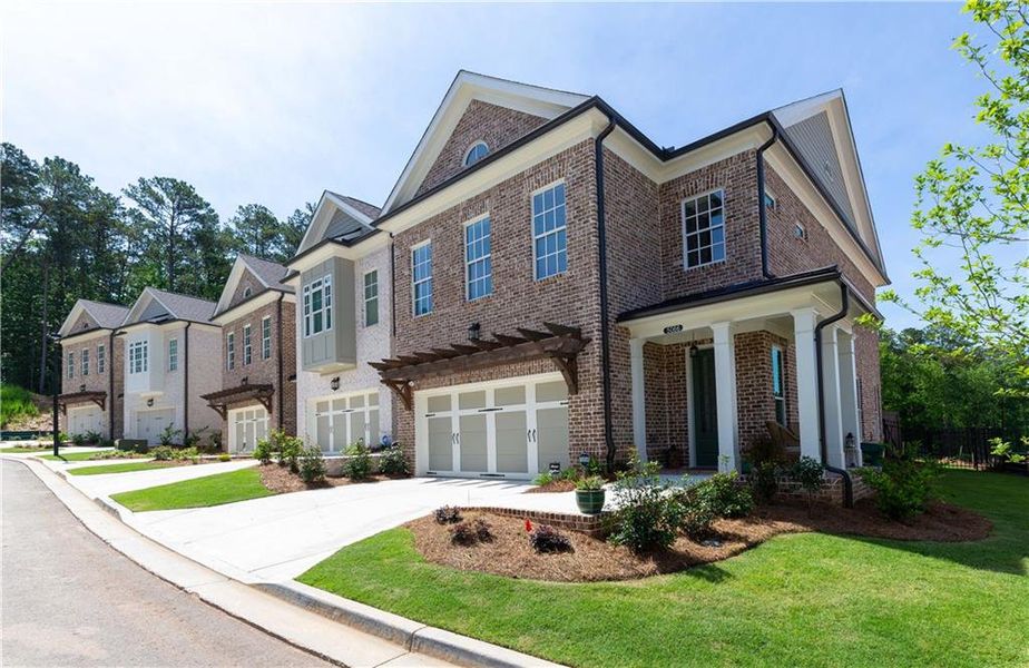 Front exterior of a new home in Waterside Townhomes, Peachtree Corners, GA, highlighting curb appeal (Image 23). Front exterior of a new home in Waterside Townhomes, Peachtree Corners, GA, highlighting curb appeal (Image 23).