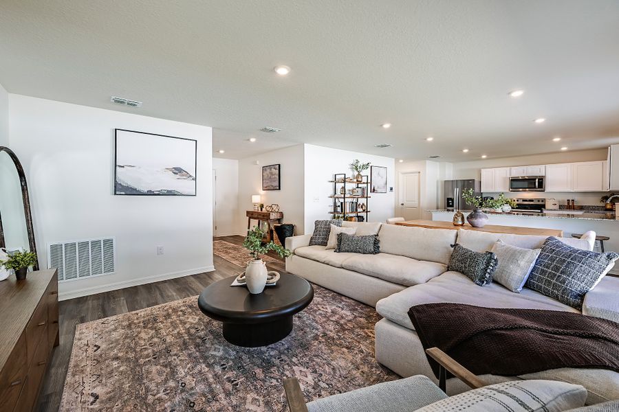 A large living room with a couch and a coffee table. A large living room with a couch and a coffee table.