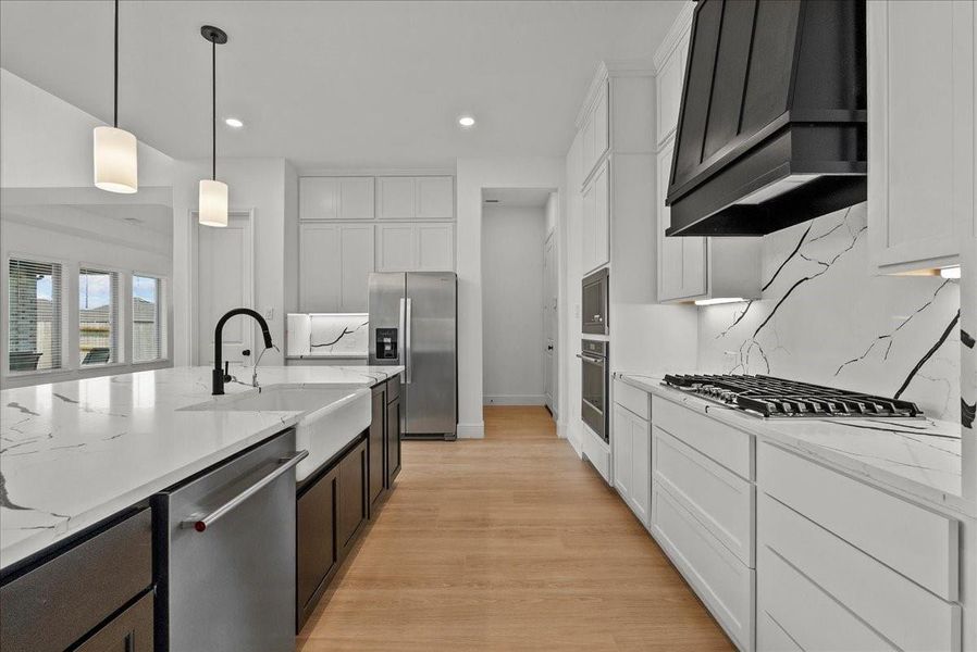 Chef’s eat-in island Kitchen features lengthy quartz countertops