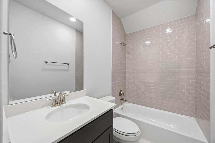 Classic Vibes: The chic Secondary Bath, nestled between the secondary bedrooms, offers a stylish and contemporary touch to your abode.