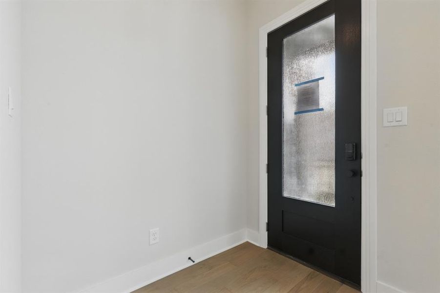 Foyer entrance featuring plenty of natural light and wood finished floors