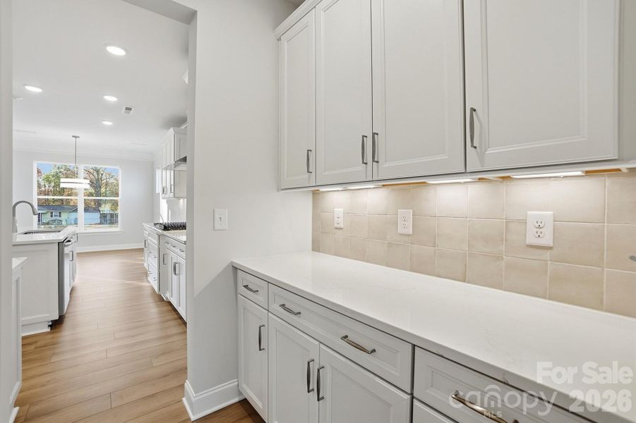 Butler pantry with upper and lower cabinets