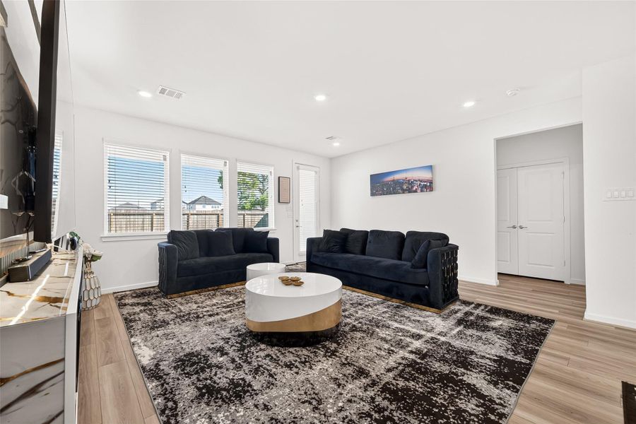 Spacious open-concept living and dining area designed for both everyday comfort and entertaining. Featuring luxury vinyl plank flooring, recessed lighting, and seamless flow into the kitchen, this inviting space offers a modern aesthetic with versatile layout options