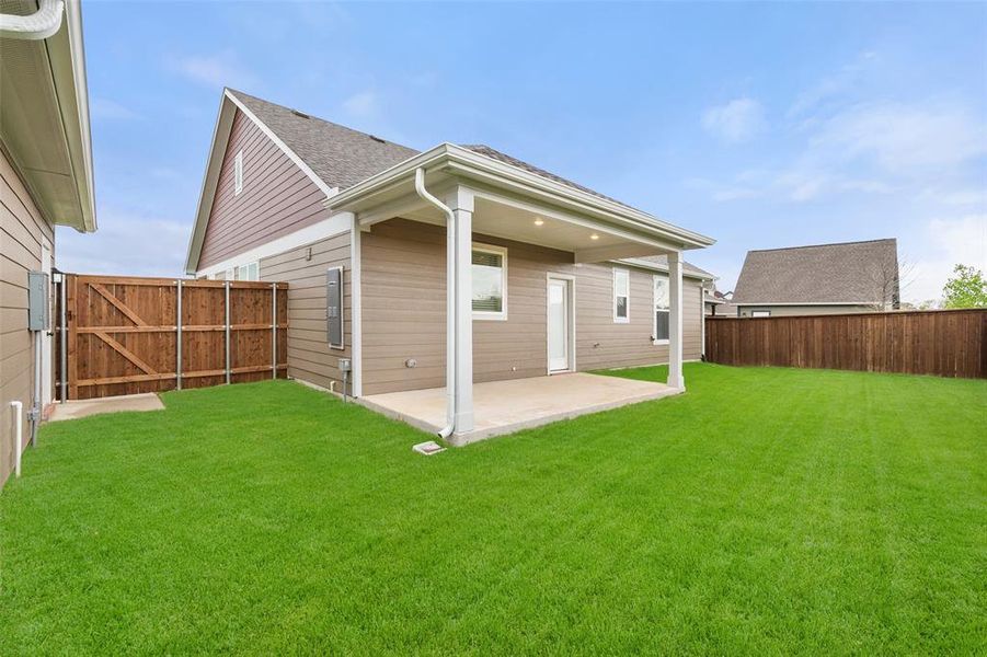 Backview of home with covered patio Backview of home with covered patio