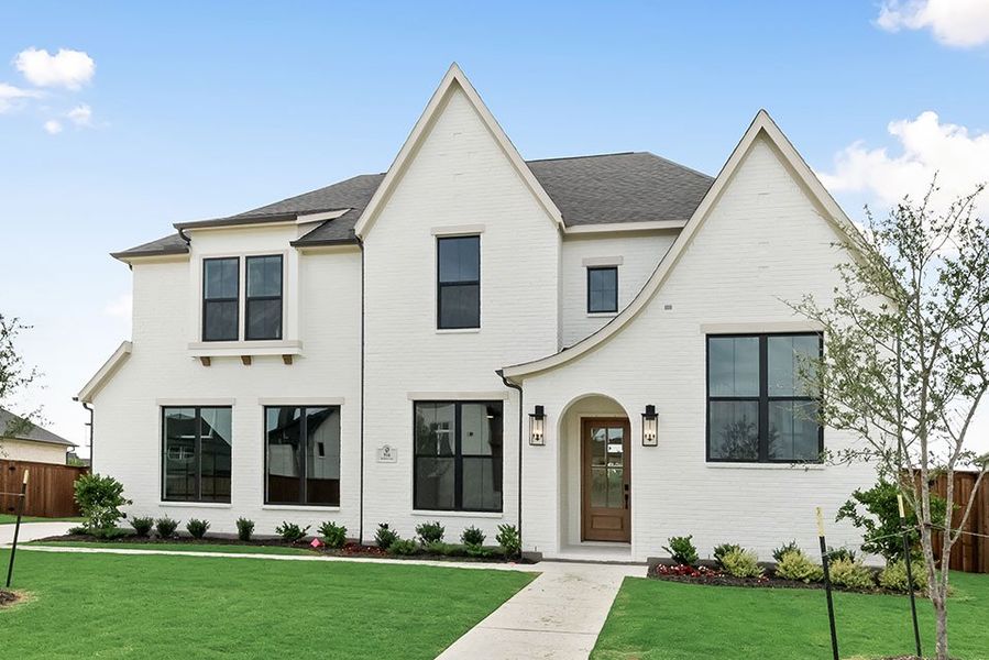 Front exterior of a new home in Light Farms Graham/Reagan, Celina, TX, highlighting curb appeal (Image 23). Front exterior of a new home in Light Farms Graham/Reagan, Celina, TX, highlighting curb appeal (Image 23).