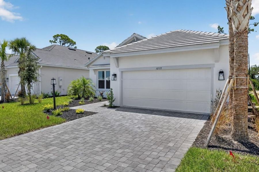 Front exterior of a new home in Skye Ranch Community Group Page, Sarasota, FL, highlighting curb appeal (Image 18).