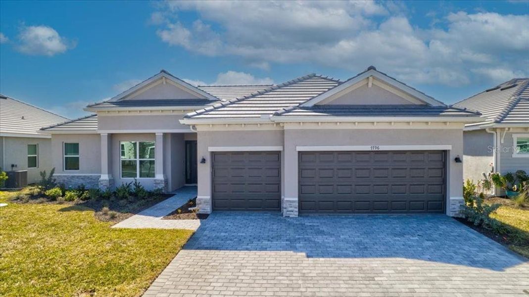 Front exterior of a new home in Harbor East, Port Charlotte, FL, highlighting curb appeal (Image 16).