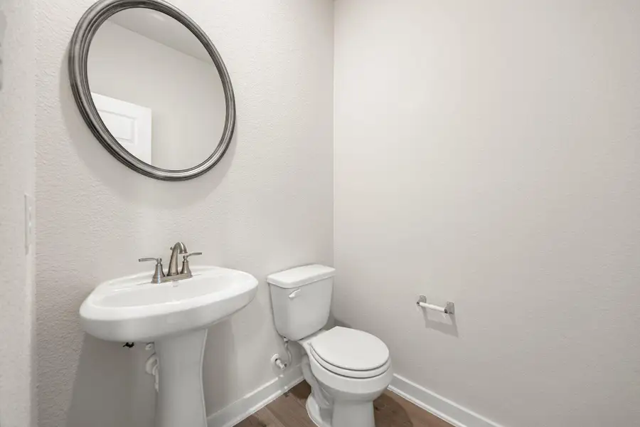 This powder room offers a clean and modern design with neutral tones, a pedestal sink, and elegant fixtures—ideal for guests and everyday convenience. This powder room offers a clean and modern design with neutral tones, a pedestal sink, and elegant fixtures—ideal for guests and everyday convenience.